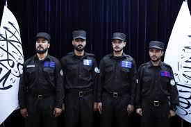 Taliban officials distribute new uniform among police
